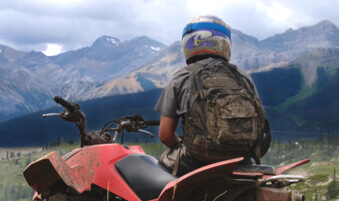 ATV rider admiring mountain scenery