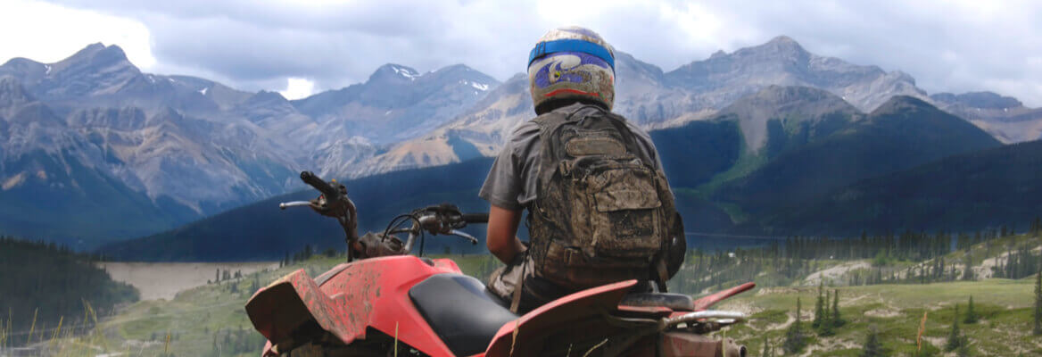 ATV rider admiring mountain scenery